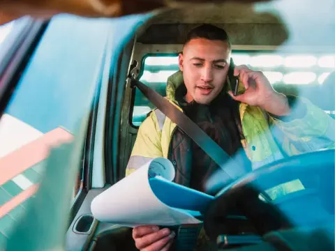 man sat on the phone in van