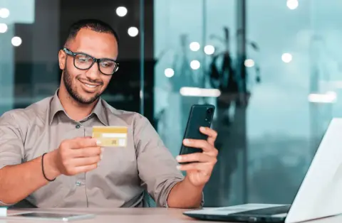 man looking at fuel card with his phone
