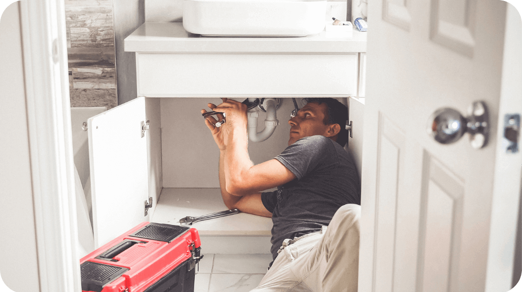 Person fixing a sink